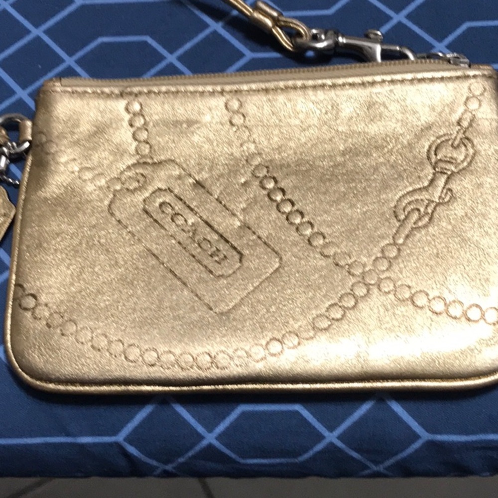Coach, gold leather wristlet with leather strap